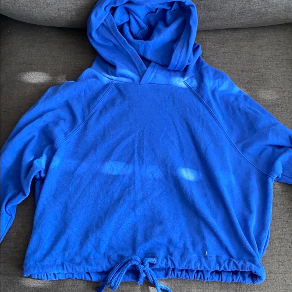 Blue hoodie, it is cropped at my waistline.